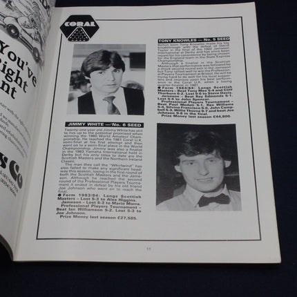 Open book with black and white photos and text of two men, likely from a sports or entertainment context.