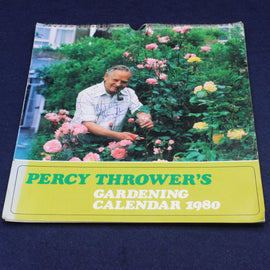 Percy Thrower's Gardening Calendar 1980 with a man gardening in a garden on a blue background