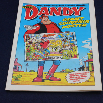 Cover of 'The Dandy' comic book with a character holding a giant souvenir poster.