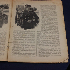 Open book with a black and white illustration of a man in uniform on a dark background