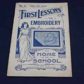 Vintage book cover titled 'First Lessons in Embroidery' on a dark background