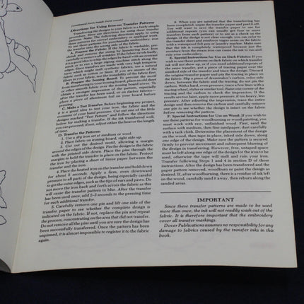 Open book with text and illustrations on a black background