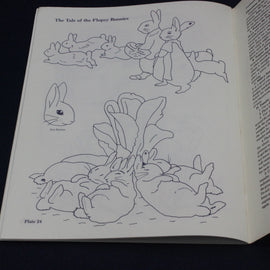 Open book with line drawings of bunnies on a black background