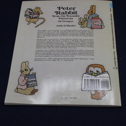 Back cover of a book titled 'Peter Rabbit Iron-On Transfer Patterns' with illustrations and text.