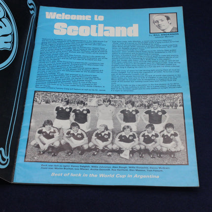 Vintage footballr brochure with a team photo and text about Scotland, featuring a blue background.
