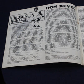 Open book with text and a graphic of a character on a dark background