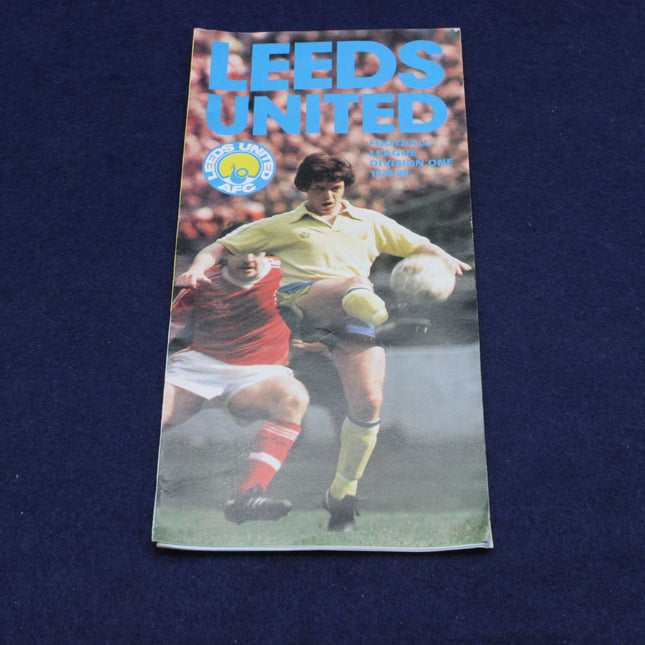 Leeds United football club leaflet with a player kicking a ball on the cover against a dark blue background
