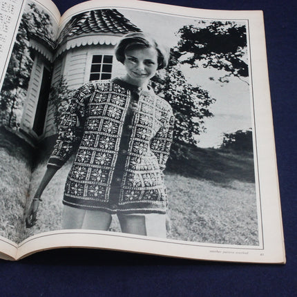 Open book showing a black and white photo of a woman wearing a patterned dress.