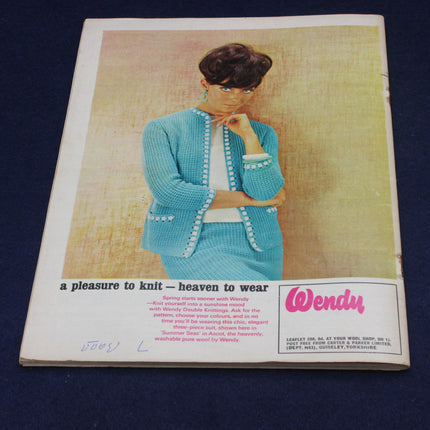 Vintage knitting pattern book cover with illustration of a woman wearing a blue knitted outfit, featuring the brand 'Wendy'.