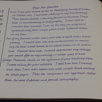 Handwritten letter on a piece of paper with visible text.