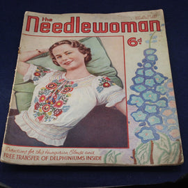 Vintage magazine cover titled 'The Needlewoman' featuring a woman in an embroidered blouse.