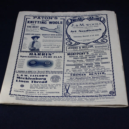 Vintage advertisement page with text and logos on a dark background