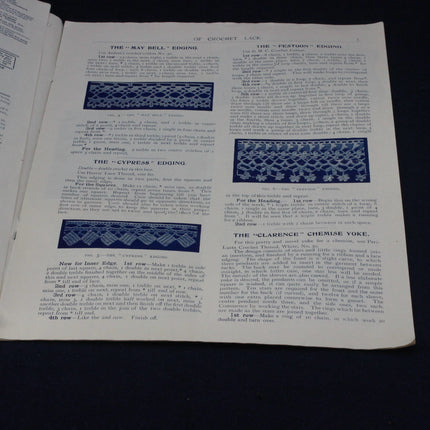 Page from a book or magazine with text and blue crochet patterns on a black background