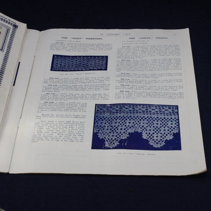 Open book with text and blue lace patterns on a dark background