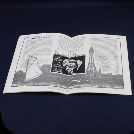 Open Reginald Dixon MBE Souvenir Booklet with black and white illustrations and text on a dark background
