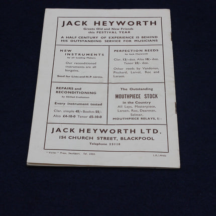 Vintage advertisement for Jack Heyworth musical instrument company on a dark background