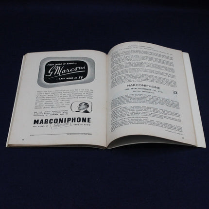 Open 1952 Northern Radio Show Catalogue with Marconiphone advertisements on a dark background