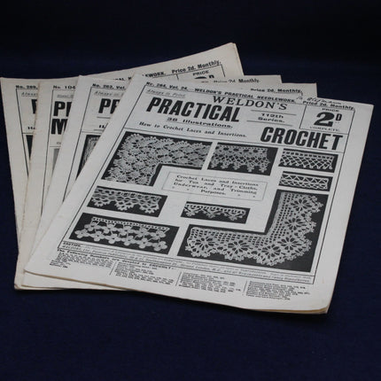Stack of vintage crochet pattern books on a dark background