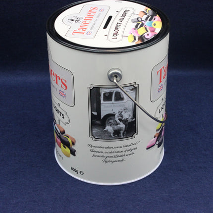 Taveners liquorice allsorts tin with a spoon on a blue background