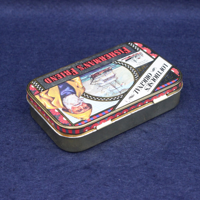Small Fisherman's Friend rectangular tin box with colorful design on a blue background