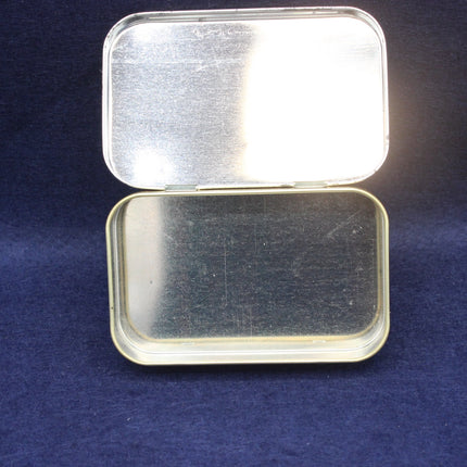 Metallic tin with a lid on a dark blue background