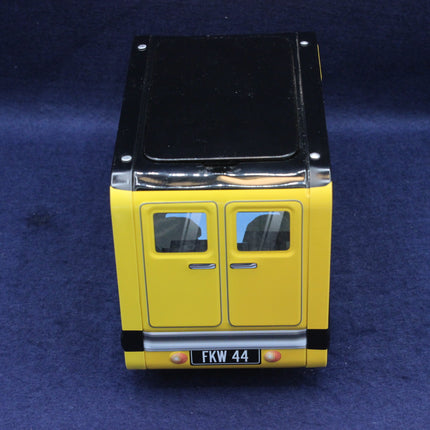 Model of a yellow vehicle with black top on a blue background