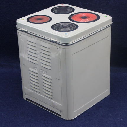Rectangular metal box with red and black circular components on a blue background