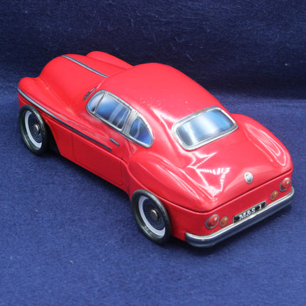 Red toy car on a blue textured background