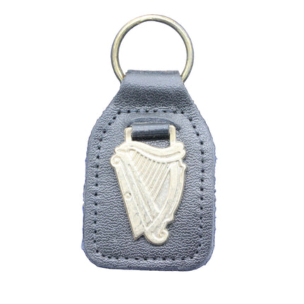 Keychain with harp design on a blue fabric background
