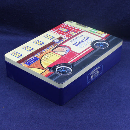 Biscuit tin with vintage car design on a blue background