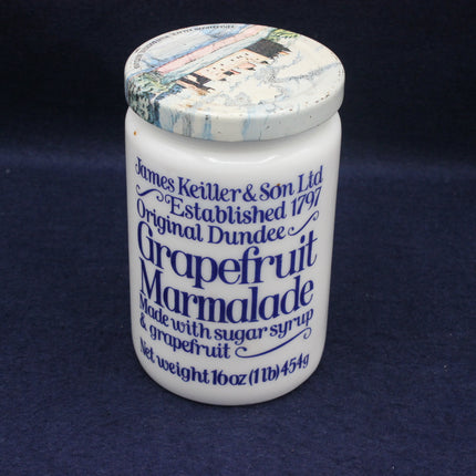 Jar of Original Dundee Grapefruit Marmalade with decorative lid on a dark background