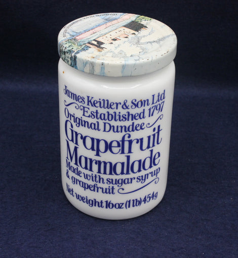 Jar of Original Dundee Grapefruit Marmalade with decorative lid on a dark background
