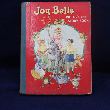 Vintage children's book titled 'Joy Bells' with illustrations on a dark background