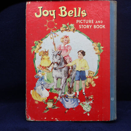 Vintage 'Joy Bells' picture and story book with colorful illustrations on a red background.