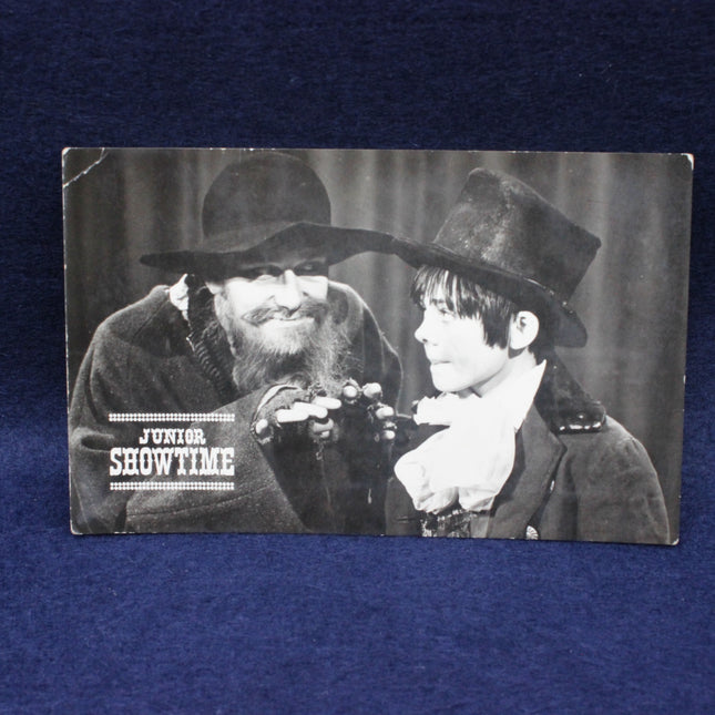 Vintage-style photo of two men in formal attire with 'Junior Showtime' text.