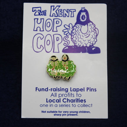Green and gold lapel pin on a card with 'The Kent Hop Cops' branding