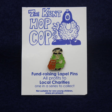 Kent Hop Cops lapel pin on a card with text about local charities