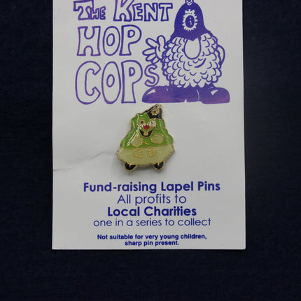 Pin on a card with 'The Kent Hop Cops' branding and information about fund-raising lapel pins.