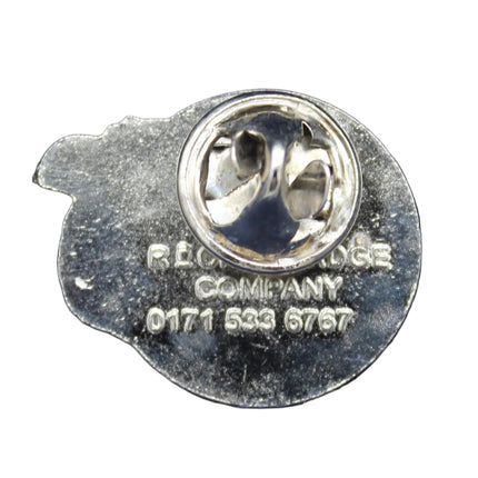 Close-up of a silver earring on a blue fabric background