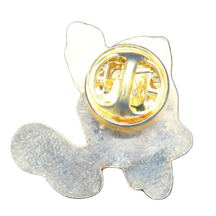 Metallic dog-shaped object with a gold center on a blue textured background