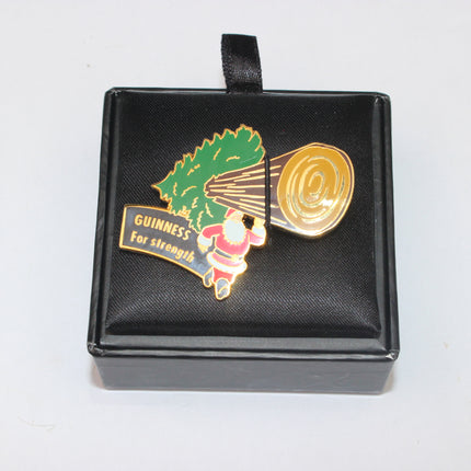 Guinness-themed lapel pin in a black box on a white background