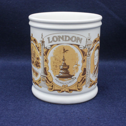 White mug with gold and brown London-themed design on a blue background