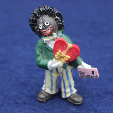 Figurine holding a red heart and money on a blue background
