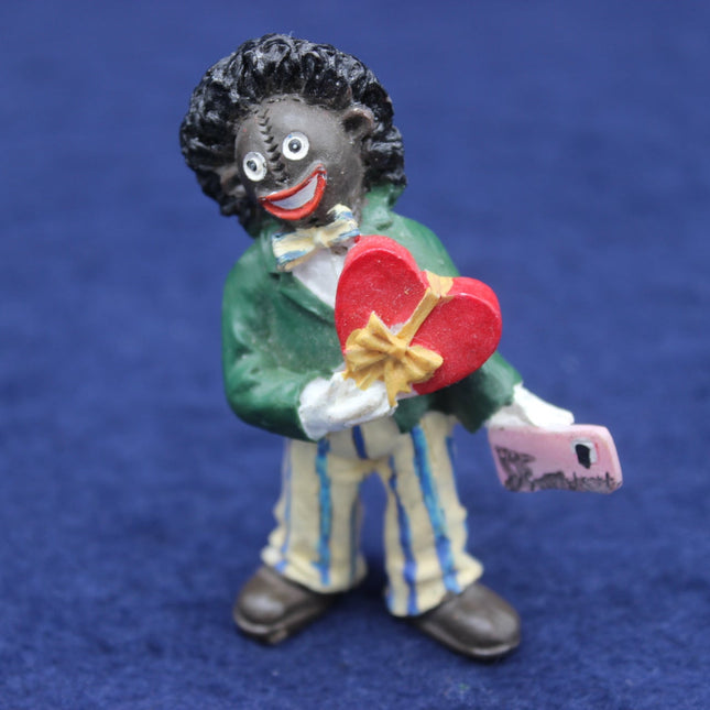Figurine holding a red heart and money on a blue background