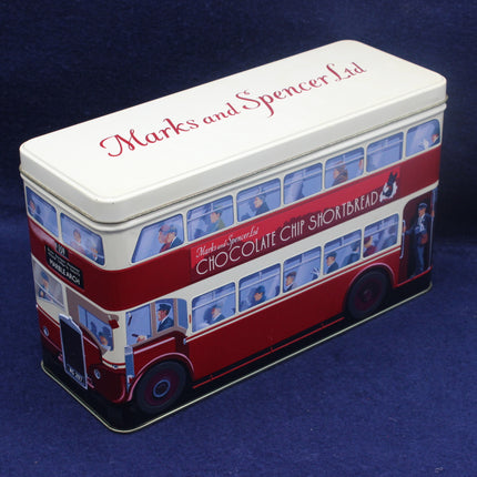 Marks and Spencer chocolate chip shortbread tin shaped like a double-decker bus on a blue background