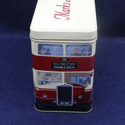 Tin canister with a design of a vintage bus on a blue background