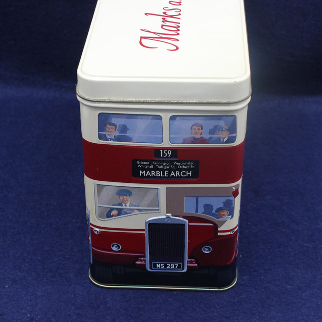 Tin canister with a design of a vintage bus on a blue background