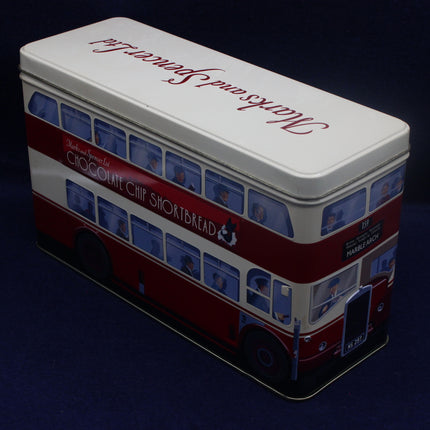 Tin shaped like a double-decker bus with 'Walkers Shortbread' branding on a dark background