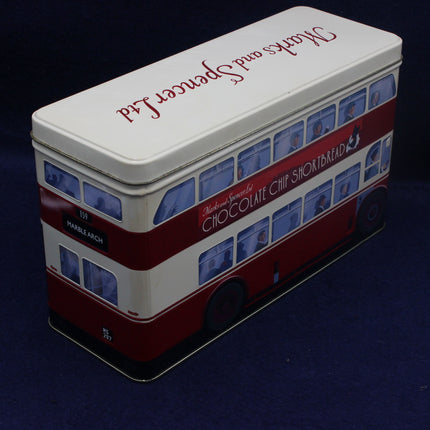 Tin shaped like a double-decker bus with branding on a dark background
