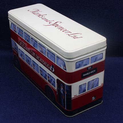 Tin canister designed like a double-decker bus with branding on a dark blue background